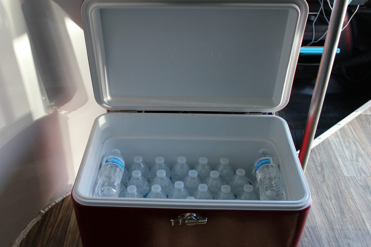 An open cooler full of bottled water on the shuttle floor